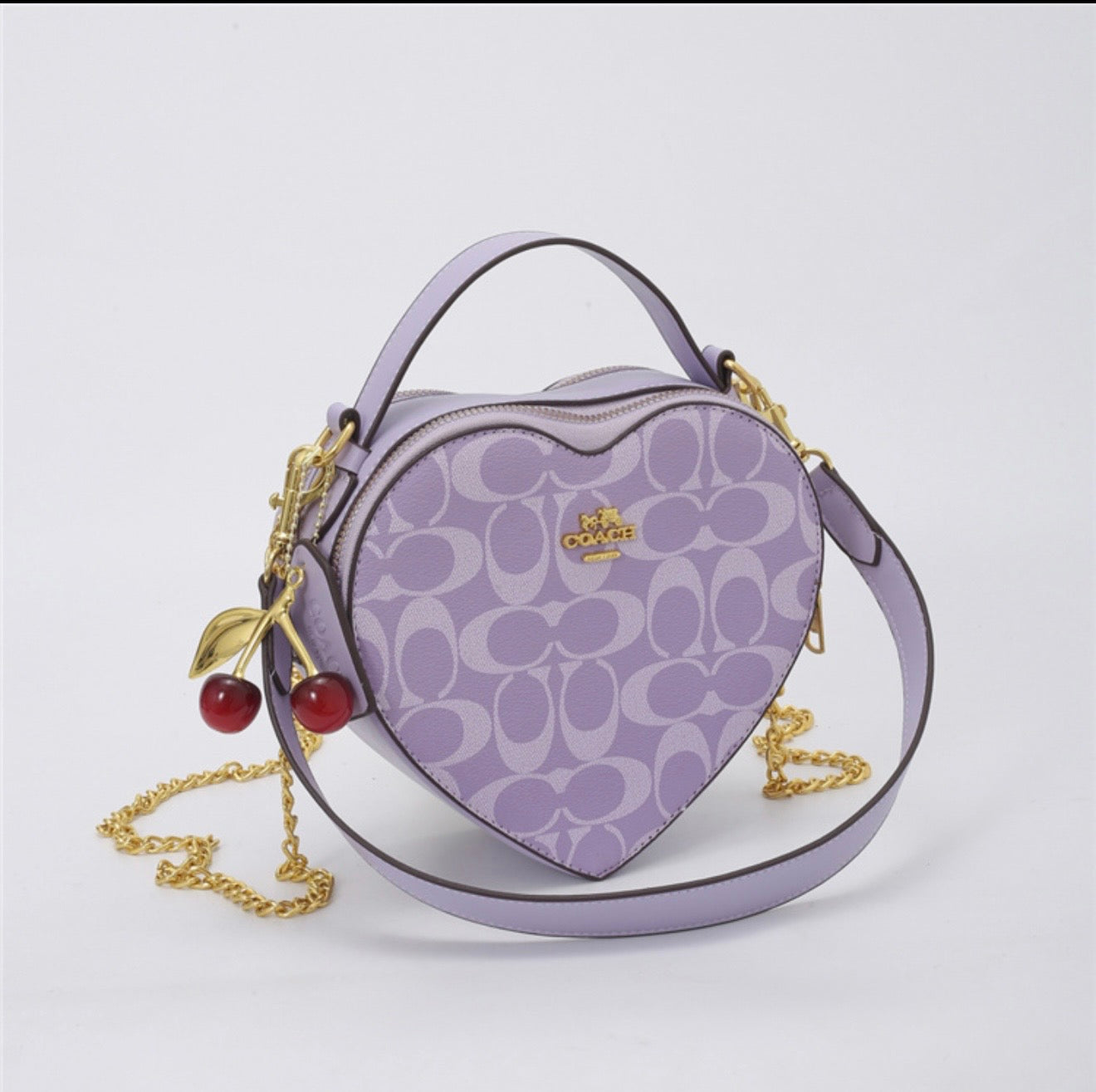 Heart shape coach bag with charm